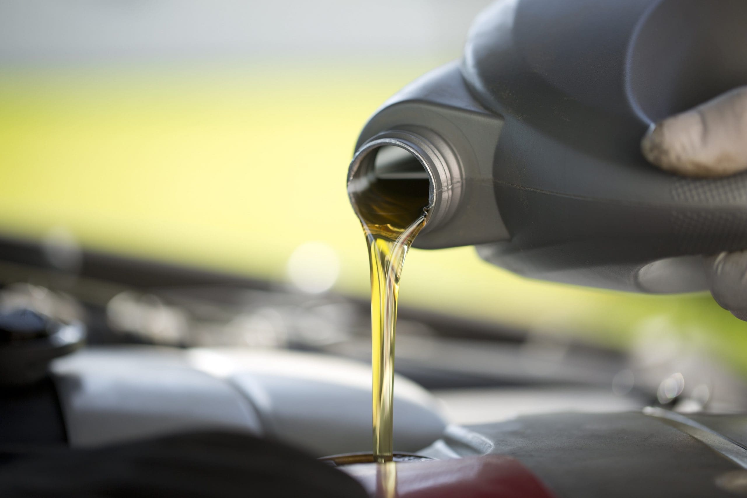 pouring engine oil into car