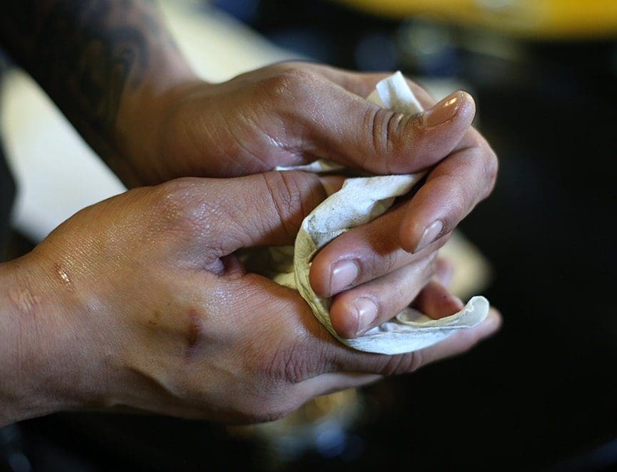 wiping hands with shop towel